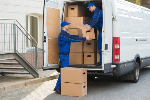 Removal van and moving team working in Crystal Palace residential street
