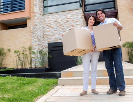 Movers carrying furniture on a residential street in Crystal Palace